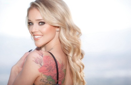 Белокурая порнозвезда Кали Роуз позирует обнаженной на траве у океана 3